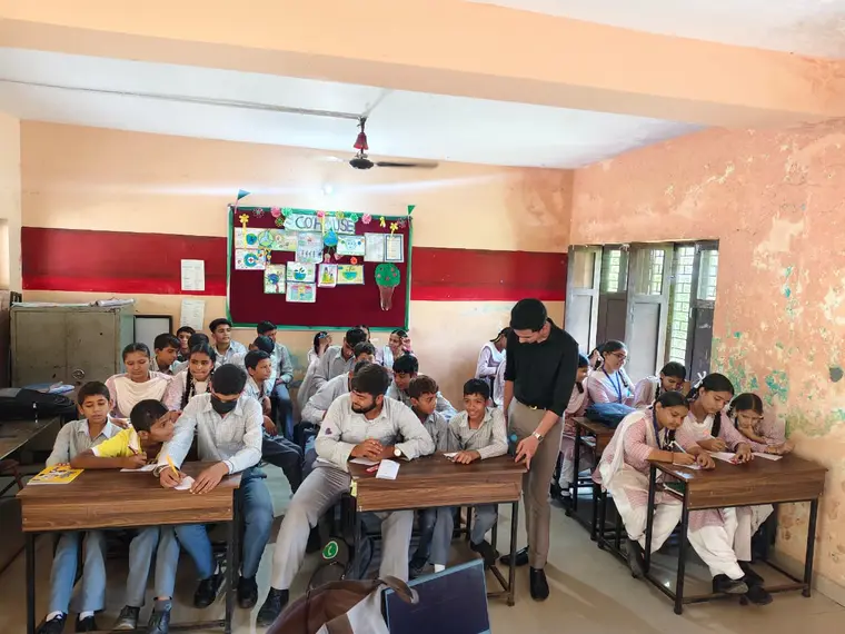 Facilitator working with students on an activity