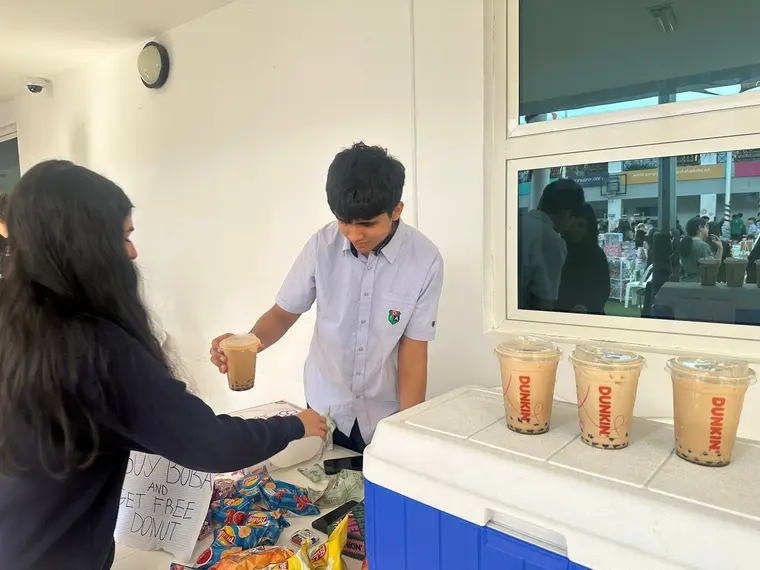 Students running a bubble tea fundraiser stall